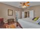 Bright bedroom featuring a ceiling fan, wooden floors, and a comfortable queen-sized bed at 6 Desert Dawn Ln, Henderson, NV 89074
