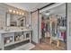 Walk-in closet and bathroom featuring a large vanity, a sliding barn door and hardwood floors at 6 Desert Dawn Ln, Henderson, NV 89074