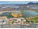 High aerial perspective reveals the lake, buildings, and desert community near the mountains at 6 Desert Dawn Ln, Henderson, NV 89074