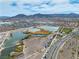 Panoramic aerial view of a lake, desert community, with tennis & basketball courts at 6 Desert Dawn Ln, Henderson, NV 89074