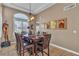 Elegant dining room features dark wood table and chairs, complemented by unique artwork and window shutters at 6 Desert Dawn Ln, Henderson, NV 89074