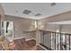 Hallway with hardwood floors and multiple light fixtures at 6 Desert Dawn Ln, Henderson, NV 89074