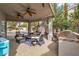Comfortable covered outdoor patio and grilling area next to a swimming pool at 6 Desert Dawn Ln, Henderson, NV 89074