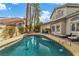 Backyard view of a pool and covered patio with comfortable lounge seating at 6 Desert Dawn Ln, Henderson, NV 89074
