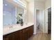 Bright bathroom with double sink vanity, large mirror, and separate toilet room at 6237 Glimmering Light Ave, Las Vegas, NV 89139