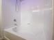 White bathtub with tile surround and chrome shower fixtures at 6237 Glimmering Light Ave, Las Vegas, NV 89139