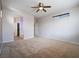 A primary bedroom featuring neutral colored walls, carpeted floors, and a view into the bathroom at 6237 Glimmering Light Ave, Las Vegas, NV 89139