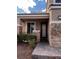 Close-up of a home's entrance with stone pillars, a brick walkway, and a decorative glass door at 6237 Glimmering Light Ave, Las Vegas, NV 89139