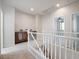 Bright hallway with neutral colors and wood railing at 6237 Glimmering Light Ave, Las Vegas, NV 89139
