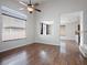 Living room with high ceilings, light gray walls, and hardwood floors that lead to an open concept kitchen at 6237 Glimmering Light Ave, Las Vegas, NV 89139