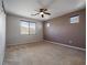 Spacious main bedroom with neutral carpet, ceiling fan, and large window at 6237 Glimmering Light Ave, Las Vegas, NV 89139