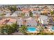 Aerial view of a home with a refreshing blue pool and lush palm trees in a desert community at 6320 Vicuna Dr, Las Vegas, NV 89146