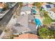 Aerial view of a home with a refreshing blue pool and lush palm trees in a desert community at 6320 Vicuna Dr, Las Vegas, NV 89146