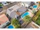 Aerial view of a home with a refreshing blue pool and lush palm trees in a desert community at 6320 Vicuna Dr, Las Vegas, NV 89146