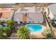 Aerial view of a home with a refreshing blue pool and lush palm trees in a desert community at 6320 Vicuna Dr, Las Vegas, NV 89146