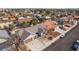 An aerial view of a home with a two-car garage and desert landscaping, located on a quiet street in a residential area at 6320 Vicuna Dr, Las Vegas, NV 89146