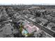 An aerial shot of a home with a pool and mature trees in a suburban neighborhood near the Las Vegas strip in the distance at 6320 Vicuna Dr, Las Vegas, NV 89146