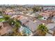 Aerial view of a home with a refreshing blue pool and lush palm trees in a desert community at 6320 Vicuna Dr, Las Vegas, NV 89146