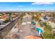 Aerial view of a home with a refreshing blue pool and lush palm trees in a desert community at 6320 Vicuna Dr, Las Vegas, NV 89146