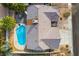 This aerial view highlights a home with a backyard pool, patio and a large roof, nestled in a quiet residential neighborhood at 6320 Vicuna Dr, Las Vegas, NV 89146