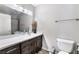 Well-lit bathroom featuring a large mirror, a modern vanity with a vessel sink, and a toilet at 6320 Vicuna Dr, Las Vegas, NV 89146