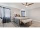 Bright bedroom with a ceiling fan, wood floors, and large windows that bring in lots of natural light at 6320 Vicuna Dr, Las Vegas, NV 89146