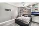 Cozy bedroom featuring built-in shelves, neutral tones, and a contemporary bed frame at 6320 Vicuna Dr, Las Vegas, NV 89146