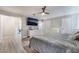 Spacious main bedroom with a view into the main bath and walk-in closet; also includes gray wood floors at 6320 Vicuna Dr, Las Vegas, NV 89146