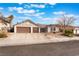 Charming single-story home boasts a two-car garage and low-maintenance desert landscaping in front yard at 6320 Vicuna Dr, Las Vegas, NV 89146