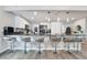 Bright kitchen featuring seating at a large bar-top, with white cabinets and stainless steel appliances at 6320 Vicuna Dr, Las Vegas, NV 89146