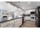 Modern kitchen featuring white cabinets, stainless steel appliances, and a spacious dark countertop at 6320 Vicuna Dr, Las Vegas, NV 89146