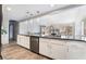 Bright modern kitchen and living area featuring bar seating, a white brick fireplace, and stainless steel appliances at 6320 Vicuna Dr, Las Vegas, NV 89146