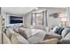 Inviting living room featuring a large TV, a cozy sectional sofa, and natural light from a bay window at 6320 Vicuna Dr, Las Vegas, NV 89146