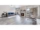 Bright living room with a charming brick fireplace, comfortable seating, and views of the pool at 6320 Vicuna Dr, Las Vegas, NV 89146