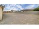 A spacious backyard with a gravel landscape and privacy fencing at 672 Lampshire Ln, Pahrump, NV 89060