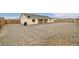 A spacious backyard with a gravel landscape and wood perimeter fencing at 672 Lampshire Ln, Pahrump, NV 89060