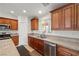 Spacious kitchen featuring stainless steel appliances, wooden cabinets, and granite countertops at 672 Lampshire Ln, Pahrump, NV 89060