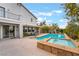 Landscaped backyard featuring a pool, spa, covered patio, and mature trees at 872 Timber Walk Dr, Henderson, NV 89052
