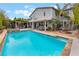 Expansive backyard with a refreshing pool, lush greenery, and an outdoor seating area at 872 Timber Walk Dr, Henderson, NV 89052