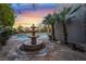 Beautiful backyard features a multi-tier fountain and lush landscaping at 872 Timber Walk Dr, Henderson, NV 89052