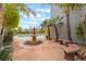 Inviting backyard with a stone fountain, swimming pool, bench, and lovely desert landscaping at 872 Timber Walk Dr, Henderson, NV 89052