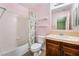 Cozy bathroom featuring a shower-tub combo, floral shower curtain, and a vanity with ample counter space at 872 Timber Walk Dr, Henderson, NV 89052