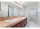 Well-lit bathroom featuring double sinks, tiled floors, and plenty of storage at 872 Timber Walk Dr, Henderson, NV 89052
