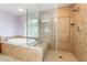 Elegant bathroom featuring a soaking tub and a tiled shower with a glass door at 872 Timber Walk Dr, Henderson, NV 89052