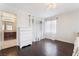 Light-filled bedroom features hardwood floors and ensuite bathroom entrance at 872 Timber Walk Dr, Henderson, NV 89052