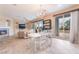 Open-concept dining and living area with fireplace and sliding door to patio at 872 Timber Walk Dr, Henderson, NV 89052