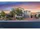 Charming two-story home with a brick driveway, stone accents, and a well-maintained front yard at sunset at 872 Timber Walk Dr, Henderson, NV 89052