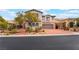 Charming two-story home with a brick driveway, stone accents, and a well-maintained front yard at 872 Timber Walk Dr, Henderson, NV 89052