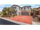 Charming two-story home with a brick driveway, stone accents, and a well-maintained front yard at 872 Timber Walk Dr, Henderson, NV 89052