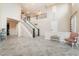 Bright and open foyer with high ceilings, tile floors, and a grand staircase with dark wood accents at 872 Timber Walk Dr, Henderson, NV 89052
